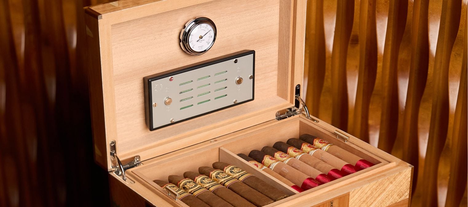 Open humidor: cedar shelves, cigars, hygrometer